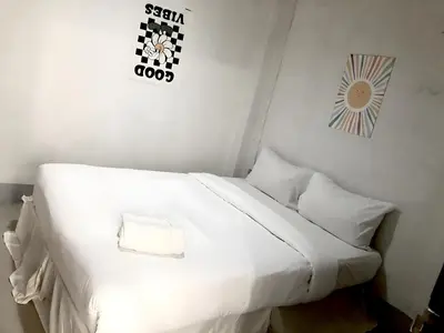 a white bed with white sheets and pillows in a room at XX Oh My Nap- Sukhumvit Soi 3 BTS Nana in Bangkok