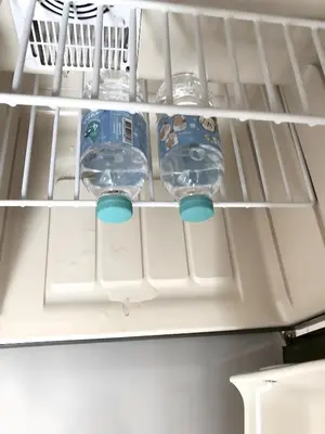 a refrigerator filled with water and water bottles at XX Oh My Nap- Sukhumvit Soi 3 BTS Nana in Bangkok