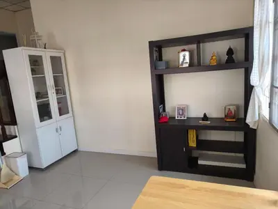 a living room with a black and white shelf at Privacy House in Ban Bang Phai