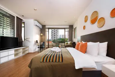 a hotel room with a large bed and a flat screen tv at King Bed, Park, BTS 5min | Free Parking, Fast WiFi in Khlong Toei