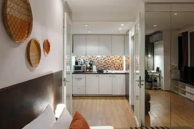 a kitchen with white cabinets and a counter top at King Bed, Park, BTS 5min | Free Parking, Fast WiFi in Khlong Toei