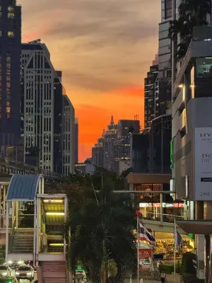 a city skyline with a sunset in the city at King Bed, Park, BTS 5min | Free Parking, Fast WiFi in Khlong Toei