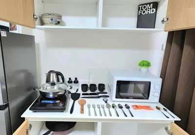 a small kitchen with a microwave and a stove at New room DMKairport,BTS, impact 340 in Ban Song Hong