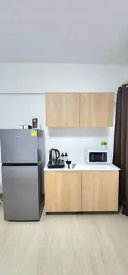 a kitchen with a refrigerator and a microwave at New room DMKairport,BTS, impact 340 in Ban Song Hong