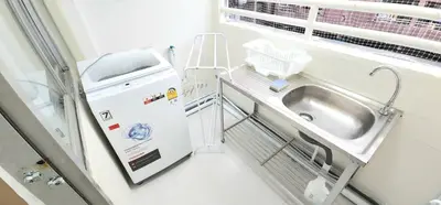 a bathroom with a sink and a washing machine at New room DMKairport,BTS, impact 340 in Ban Song Hong