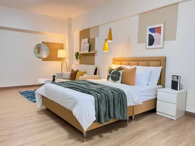 a bedroom with a large bed and a chair at new room near Don Mueang airport,Impact,BTS 339 in Ban Song Hong