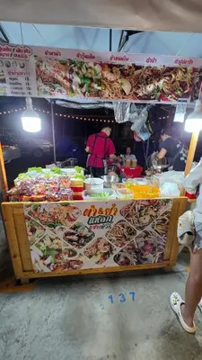 a food stand with a lot of food on display at new room near Don Mueang airport,Impact,BTS 339 in Ban Song Hong