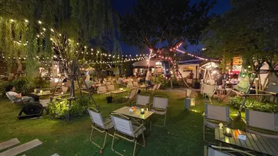 a group of tables and chairs in a yard with lights at new room near Don Mueang airport,Impact,BTS 339 in Ban Song Hong