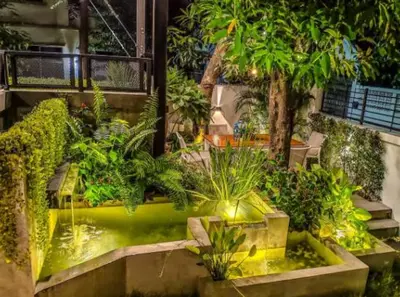a garden with a pond with plants in it at Garden and pool Villa bangkok in Bang O