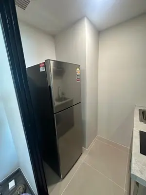 a small refrigerator with a sink in a room at Brand new Condo near ICON SIAM in Bangkok