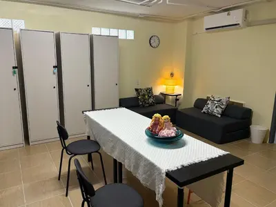 a living room with a table and a couch at NIJ Lady dorm in Bangkok