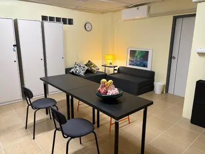 a living room with a table and a couch at NIJ Lady dorm in Bangkok