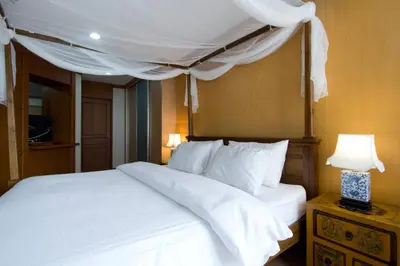 a bedroom with a white bed with a canopy at 1br with Pool Gym near BTS Phrom Phong in Khlong Toei