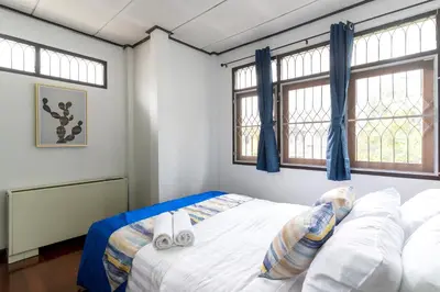 a bedroom with a bed with two towels on it at 110 House 4Bedroom in Ban Zong Katiam
