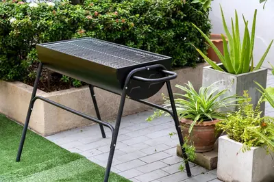 a grill sitting on the grass in a garden at 110 House 4Bedroom in Ban Zong Katiam