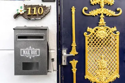 a door with a mail box and a gold grate at 110 House 4Bedroom in Ban Zong Katiam