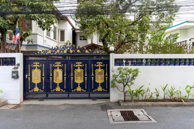 a blue and gold gate in front of a house at 110 House 4Bedroom in Ban Zong Katiam