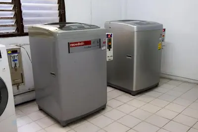 three metal trash cans sitting in a room at DD House Apartment in Bangkok
