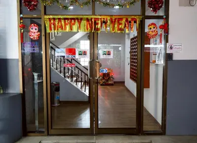 an open door to a room with a staircase with christmas decorations at DD House Apartment in Bangkok