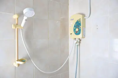 a shower in a bathroom with aitizer at DD House Apartment in Bangkok