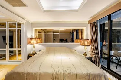 a bedroom with a large bed and two lamps at Bangrak HANGOVER 2 Central River Station in Bangkok