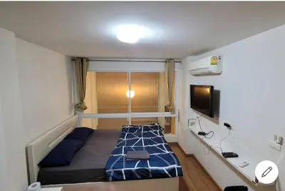 a small bedroom with a bed and a tv at Loft at sanambinnam in Ban Bang Talat