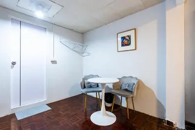 a white room with two chairs and a table in it at xx Stay On Sukhumvit Soi 11 BTS Nana - สเตย์ออน สุขุมวิท 11 รถไฟฟ้านานา in Makkasan