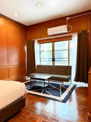 a bedroom with a couch and a table in front of a window at xx Stay On Sukhumvit Soi 11 BTS Nana - สเตย์ออน สุขุมวิท 11 รถไฟฟ้านานา in Makkasan