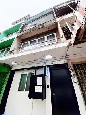 a building with a black door in front of it at xx GO INN Siriraj BKK โกอินน์ ศิริราช in Bangkok Noi