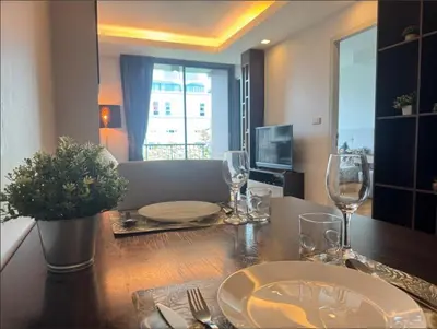a dining room table with wine glasses on it at Central Living Ploenchit in Bang Kapi