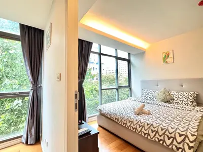 a bedroom with a bed and a large window at Central Living Ploenchit in Bang Kapi