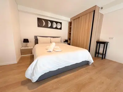 a bedroom with a large bed with white sheets at BTS onnut loft quiet room Netflix Rooftop bar in Bangkok