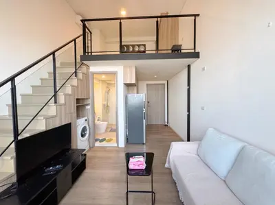 a living room with a white couch and a staircase at BTS onnut loft quiet room Netflix Rooftop bar in Bangkok