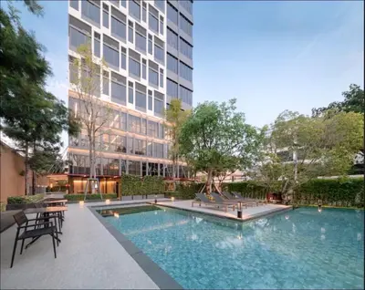 an image of a swimming pool in front of a building at BTS onnut loft quiet room Netflix Rooftop bar in Bangkok