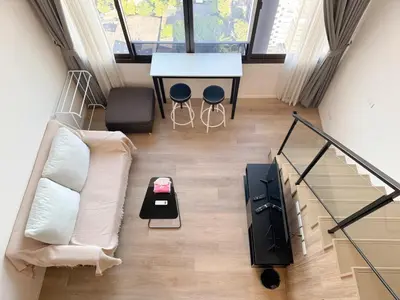 a living room with a couch and a table at BTS onnut loft quiet room Netflix Rooftop bar in Bangkok