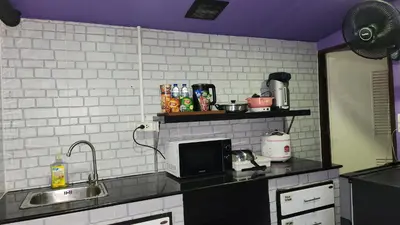 a kitchen with a sink and a counter top at Ber Ben House in Bang Su