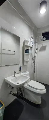 a bathroom with a toilet and a sink at Ber Ben House in Bang Su