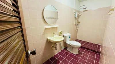 a bathroom with a toilet and a sink and a mirror at Creative Bangkok Bed in Sathani Bang Khen