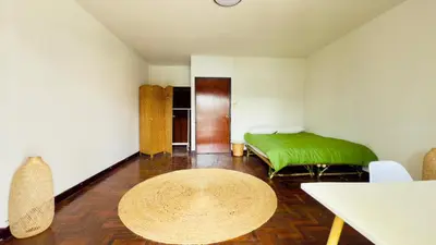 a room with a green bed and a table at Creative Bangkok Bed in Sathani Bang Khen