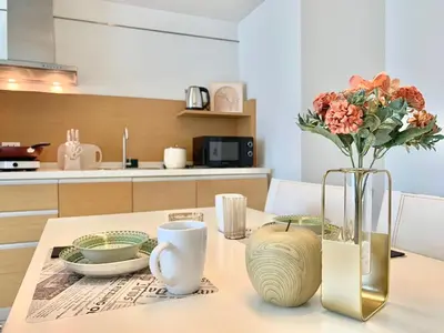 a table with a vase with flowers in a kitchen at Sathorn Prime Residence 1BR #Bangkok in Bangkok