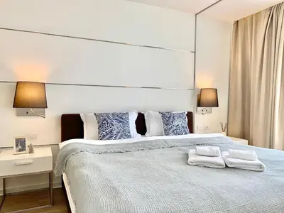 a bedroom with a large bed with two towels on it at Sathorn Prime Residence 1BR #Bangkok in Bangkok