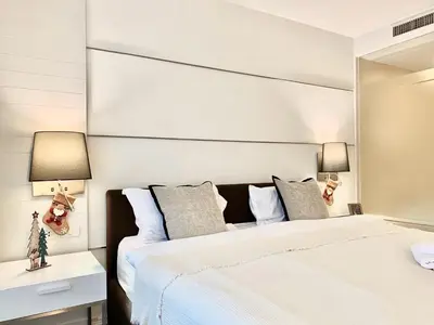 a bedroom with a large bed with a large mirror at Sathorn Prime Residence 1BR #Bangkok in Bangkok