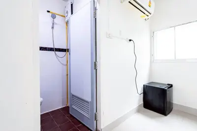 a bathroom with a shower stall and a television at XX Oh My Nap - BTS Nana โอ้ มาย แนป ซอยนานา in Bangkok
