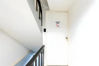 a hallway with a door with a no entry sign on it at XX Oh My Nap - BTS Nana โอ้ มาย แนป ซอยนานา in Bangkok