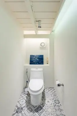 a bathroom with a white toilet in a room at Non Inn Entire Historic 5 Bedroom Riverside Shophouse near ICONSIAM for Families and Groups in Bang Rak