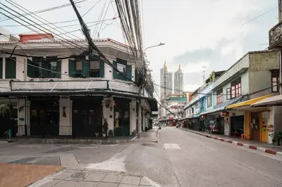 an empty street in a city with buildings at Non Inn The Post Spacious King Room with Sofa Bed and Living Area near Riverside and ICONSIAM in Bang Rak