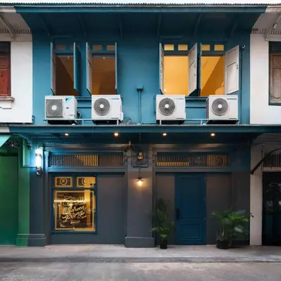 a building with speakers on the side of it at Non Inn The Diamond Artisan and Barber 4 Bedroom Riverside Retreat with King and Twin Rooms in Bang Rak
