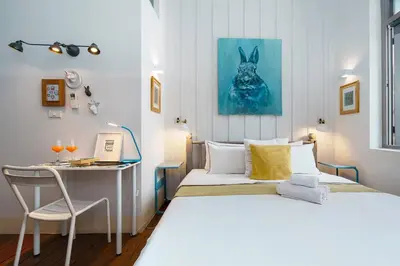 a bedroom with two beds and a desk with a computer at Non Inn The Diamond Artisan King and Twin Rooms with Private Coffee Station and InnerCourt Quiet View near Riverside and ICONSIAM in Bang Rak