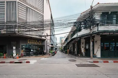 an empty street in a city with buildings at Non Inn The Post and Barber 3 Bedroom Riverside Shophouse with King and Twin Rooms in Bang Rak