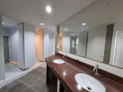 a bathroom with two sinks and two mirrors at XX The Hidden Khaosan - เดอะ ฮิดเด้น ข้าวสาร รามบุตรี 7 in Bang Bua Thong Railway Station